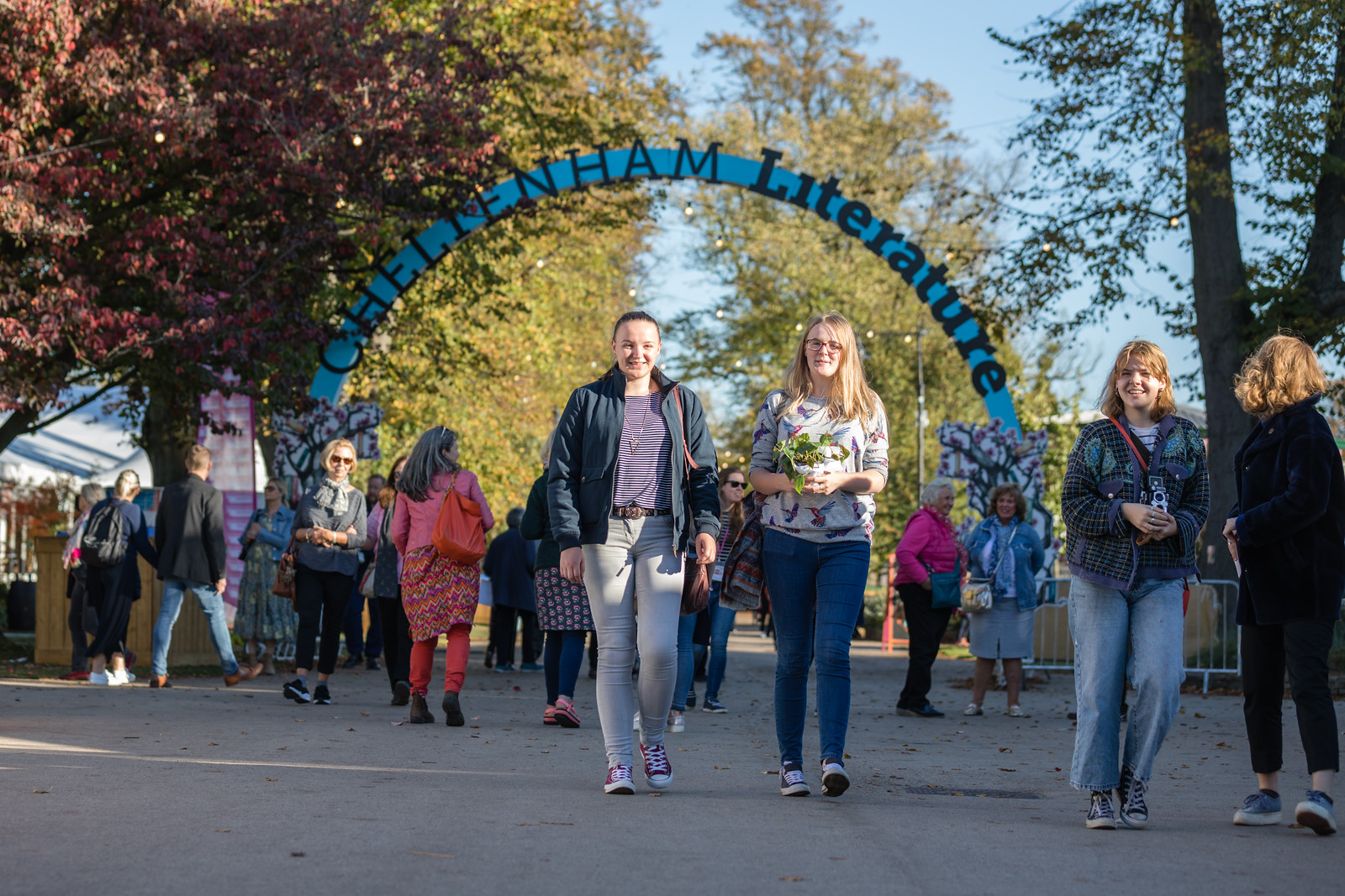 Giant arch reading Cheltenham Literature Festival with crowd of people